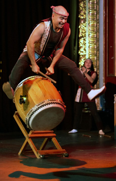 Mark H. Rooney jumps over his drum during an exuberent Matsuri solo